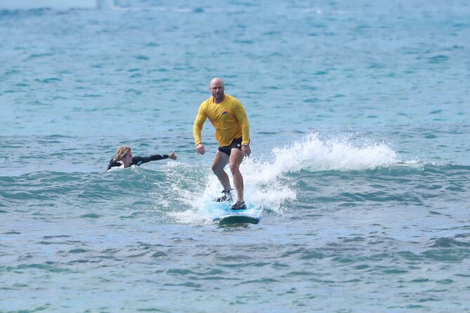 Open Group Surfing Lesson in Waikiki, Hawaii - Taking the Board Toward the Waikiki Surf Break